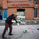 Jerald Miller helps clean up debris April 28, 2015, from a CVS pharmacy in Baltimore that was set on fire during rioting after the funeral of Freddie Gray.
Andrew Burton/Getty Images